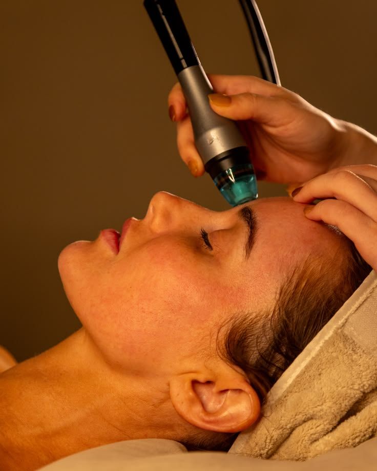 Embout Hydraface passé sur le front d'une cliente allongée, cheveux protégés par une serviette, illustration de la formation Hydraface à Marseille